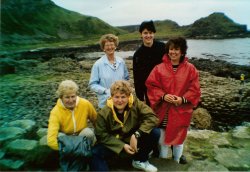 Two men and three women posing at Giant's Causeway in Ireland
